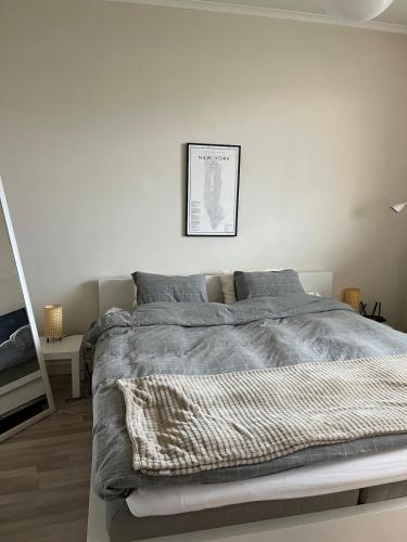 a white bedroom with a large bed in it at Cosy apartment close to the castle in Kalmar