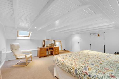 a bedroom with a bed and a chair and a desk at Hill House Hideaway - North East Escapes in Bardon Mill