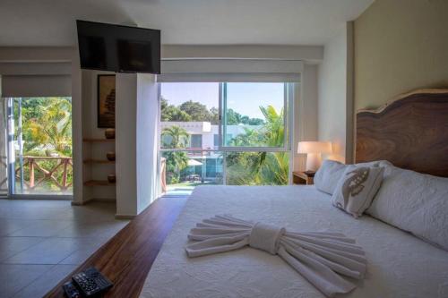 a bedroom with a large bed with a large window at Villa en Nuevo Vallarta 15 in Nuevo Vallarta 