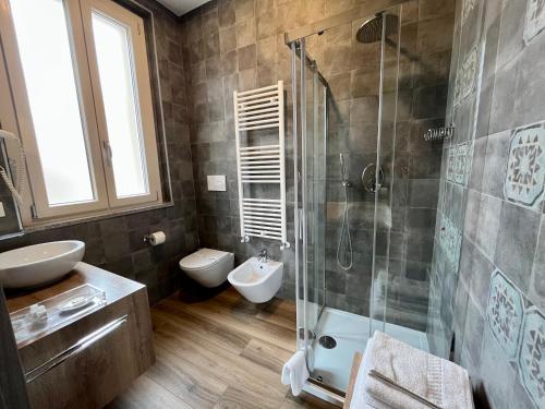 a bathroom with a shower and a toilet and a sink at Delight Rooms in Corbetta