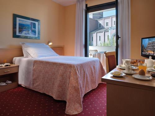 En eller flere senge i et værelse på Hotel Terme Marco Polo