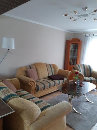 a living room with two couches and a coffee table at Ferienwohnung in Gresenhorst