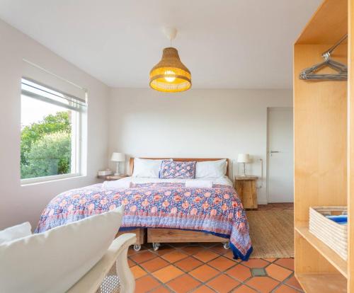 a bedroom with a bed and a window at St James Pool Cottage in St James
