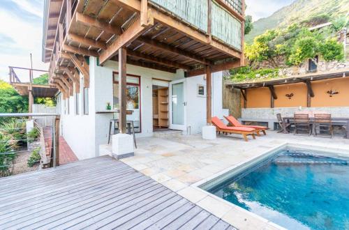 an outdoor patio with a swimming pool and a house at St James Pool Cottage in St. James