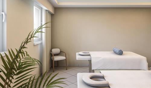 a waiting room with a table and a plant at IFA Graal-Müritz Hotel & Spa in Graal-Müritz