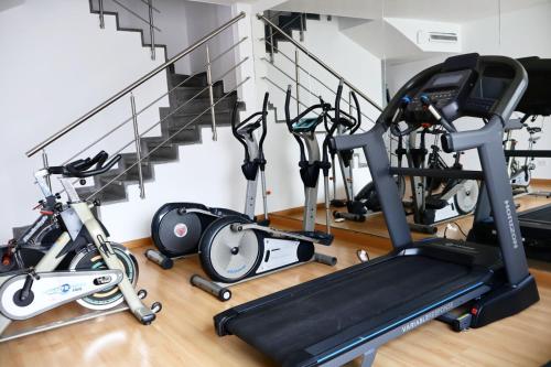 a gym with treadmills and exercise bikes next to stairs at Hotel Internacional La Triada in Bucaramanga