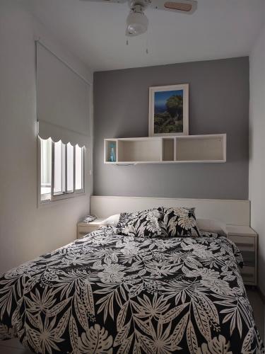 a bedroom with a bed with a black and white comforter at Miramar Atlántico Playa in Los Llanos de Aridane