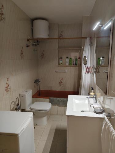 a white bathroom with a toilet and a sink at Miramar Atlántico Playa in Los Llanos de Aridane