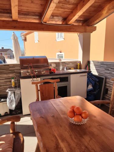 a kitchen with a wooden table and a stove at Ferienhaus Maja in Pavicini