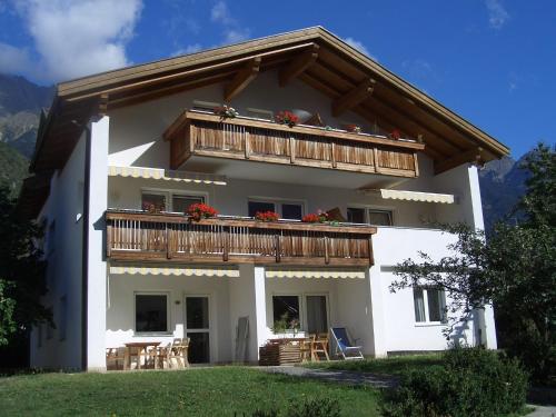 a large white house with a balcony at Ferienwohnung im Haus Texel IV in Rablà