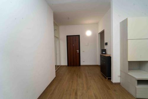 an empty room with a door and a wooden floor at AG apartment 2 in Bresso