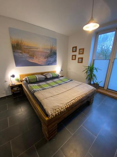 a bedroom with a large bed with a painting on the wall at Stadtvilla in Kiel