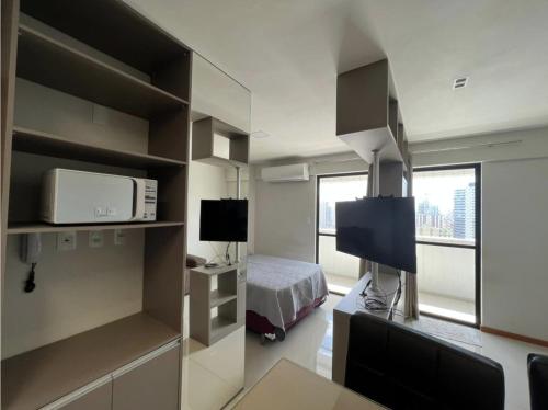 ein kleines Zimmer mit einem Bett und einem Fernseher in der Unterkunft Edificio Blue in Belém