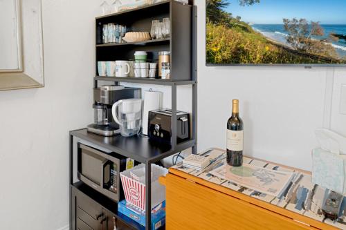 a kitchen with a counter with a bottle of wine at Danyas Room in Summerland