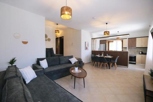 a living room with a couch and a table at Nerea Apartments in Agios Ioannis Kaspaka