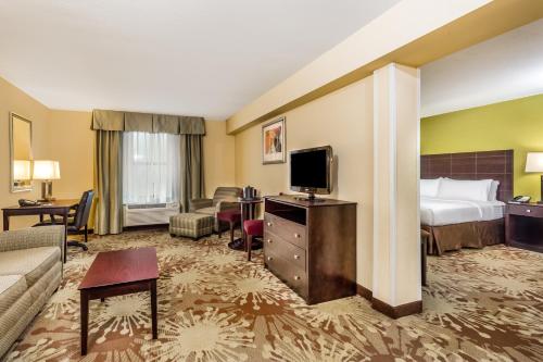 a hotel room with a bed and a television at Hotel Gurnee in Gurnee