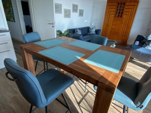 a dining table and chairs in a living room at Port Marina "Schlagseite" in Bremerhaven