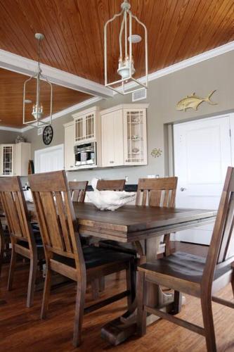 a dining room with a wooden table and chairs at Chateau on Colony Cove in Dauphin Island