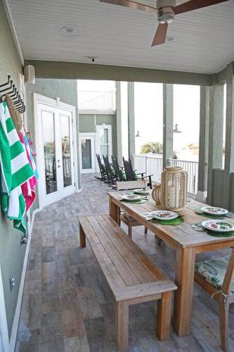 a dining room with a wooden table and chairs at Chateau on Colony Cove in Dauphin Island