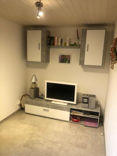 a living room with a flat screen tv on a counter at Ferienhaus Ostfriesland in Berumbur