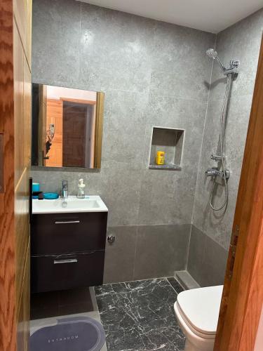 a bathroom with a shower and a sink and a toilet at Sand house in Oualidia