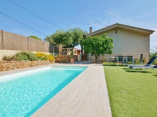 a swimming pool in front of a house at Ca la Moni Gualta in Gualta