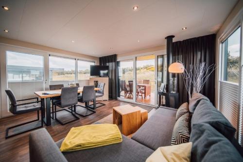 a living room with a couch and a table at Hausboot the Hideaway LP26 in Klitten