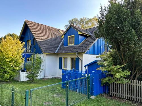 ein blau-weißes Haus mit einem Zaun in der Unterkunft Franzi 3 in Prerow