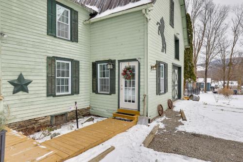 a house with a wooden porch with a star on it at Walkable Studio on Historic Hammondsport Property! in Hammondsport