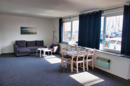 a living room with a couch and a table at Alte Segelschule in Lübeck