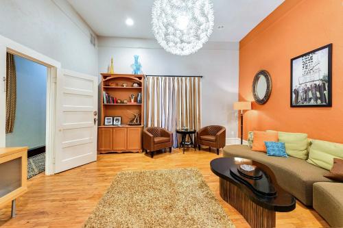 a living room with a couch and a chandelier at Historic Decatur Apt with City Square Views in Decatur