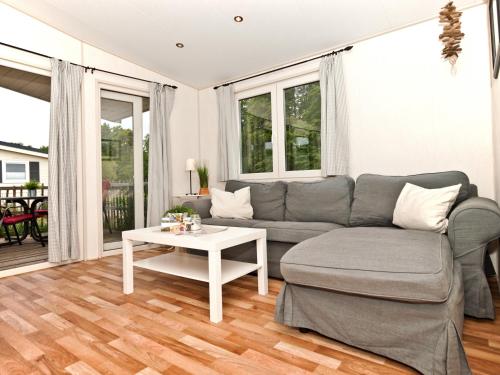 a living room with a couch and a table at Ostseeferienpark Walkyrien - Offizier 11 in Neustadt in Holstein