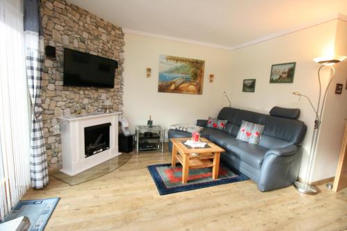 a living room with a couch and a fireplace at Alpenspatzl in Reit im Winkl