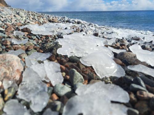 a rocky beach with melting ice on it at The Birch Plain Tower in Englishtown