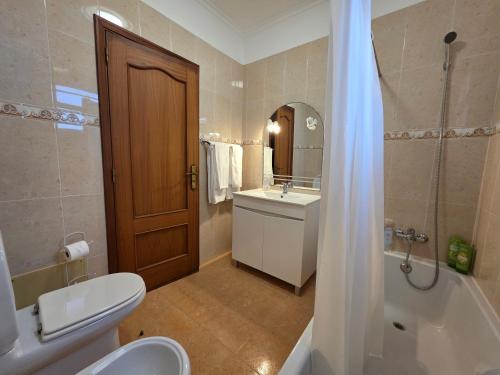 a bathroom with a toilet and a sink and a shower at Casa de Feria do Livramento in Funchal