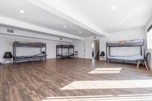 a room with two beds and a wooden floor at Affordable Dorm Hayward in Hayward