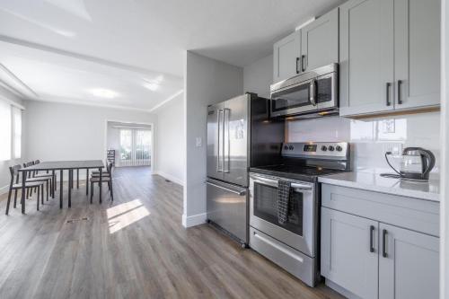 a kitchen with stainless steel appliances and a table at Affordable Dorm Hayward in Hayward