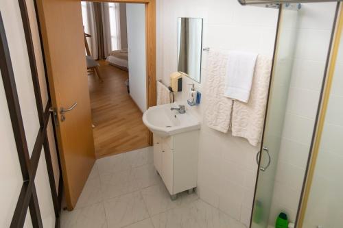 a bathroom with a sink and a mirror at Central Guest House in Ponta Delgada