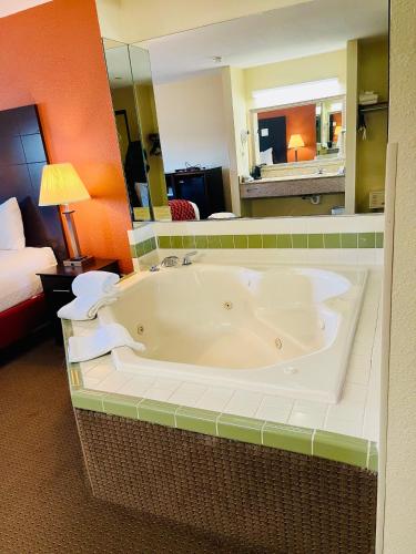 a large bath tub in a hotel room at Baymont by Wyndham Indianapolis in Indianapolis