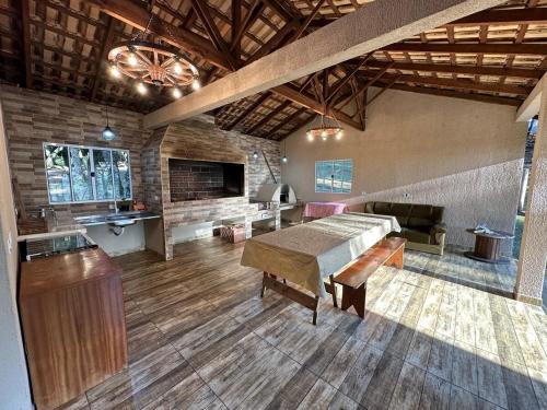 a large room with a table and a couch at Aconchego e Refúgio no Campo in Contenda