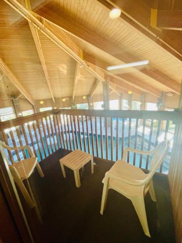 a room with two chairs and a bench and a table at Baymont by Wyndham Indianapolis in Indianapolis