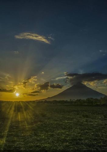 a view of a mountain with the sun in the sky at Beach cabin ometepe in Altagracia