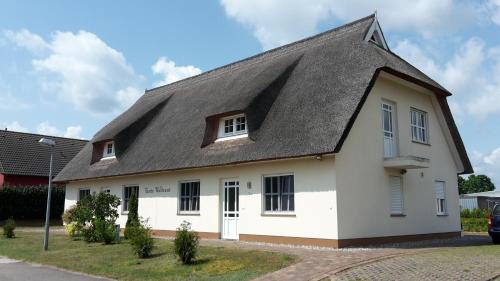 a white house with a gray roof at Häuschen "Tante Waltraut" in Garz-Usedom