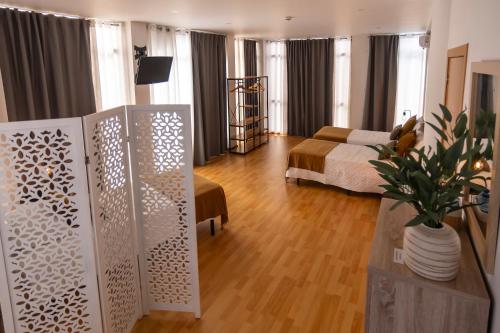 a living room with a bed and a couch at Central Guest House in Ponta Delgada