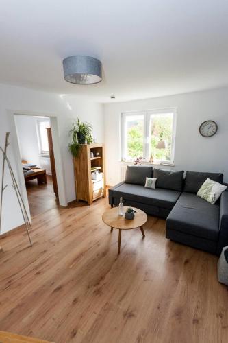 a living room with a couch and a table at Ferienwohnung Naumann in Schotten
