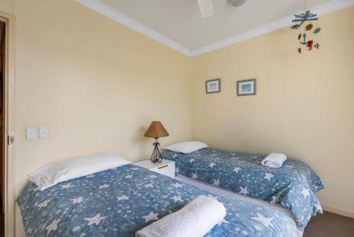 two beds sitting next to each other in a bedroom at 6- 'Cote D'Azur' 6 Douglas Street Sunshine Beach in Sunshine Beach