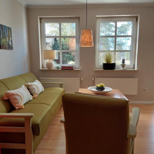 a living room with a couch and a table at "SüdWest" Ferienwohnung in Prerow