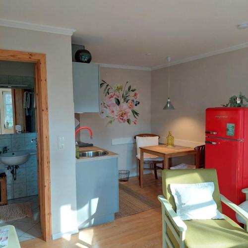 a kitchen with a red refrigerator and a table at "SüdWest" Ferienwohnung in Prerow