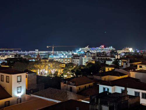 a view of a city at night at Top-Floor One-Bedroom Flats - Peaceful with Ocean and City Views in Funchal