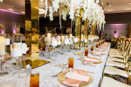 a long table with chairs and candles and flowers at Marriott Dallas Allen Hotel & Convention Center in Allen